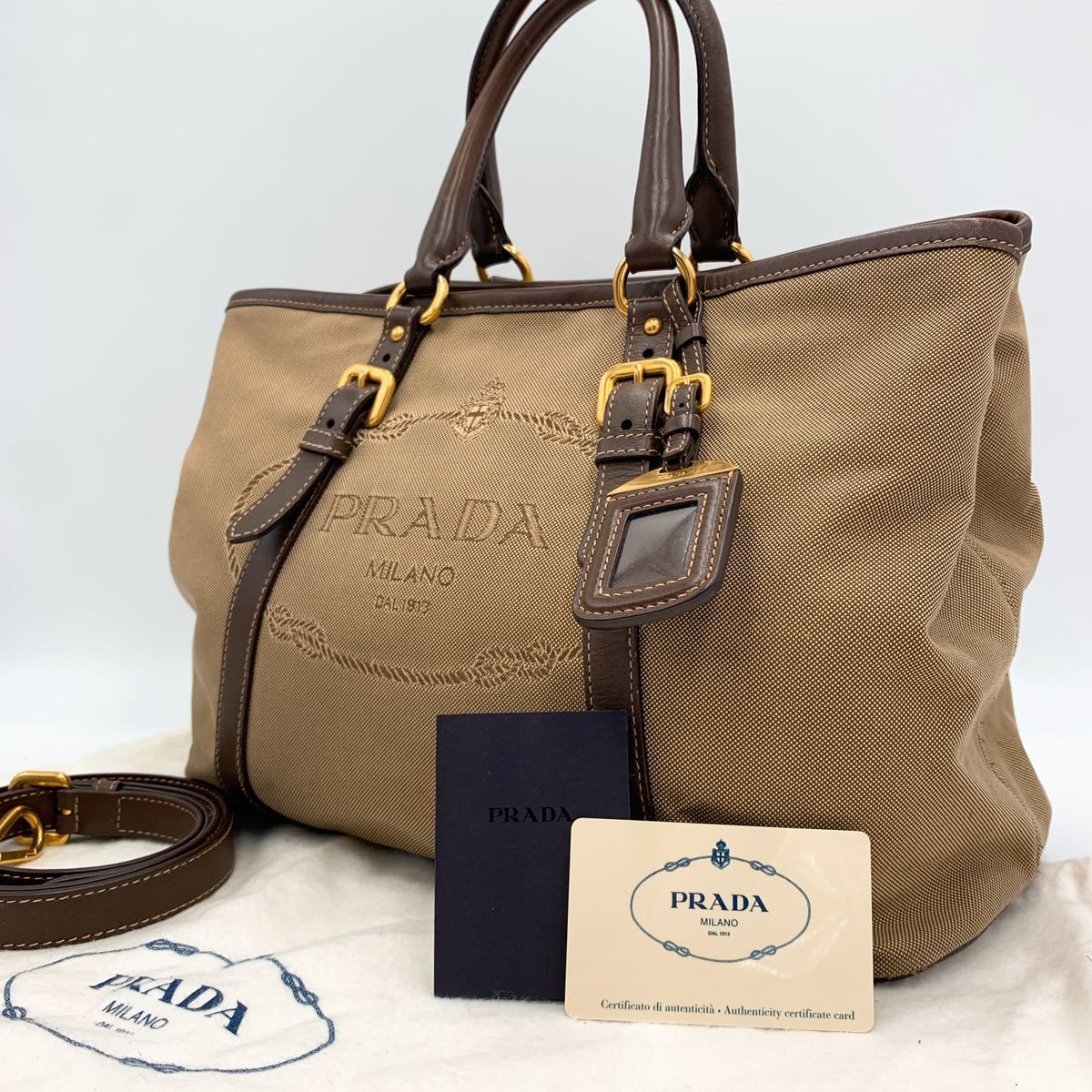 定番，新作登場 1円 PRADA プラダ ロゴジャガード 2way ハンド ショルダー キャンバス レザー 革 金具 スタッズ 通勤 A4 書類 白タグ ブラウン 茶(ハンドバッグ)｜売買されたオークション情報、yahooの商品情報を かばん、バッグ