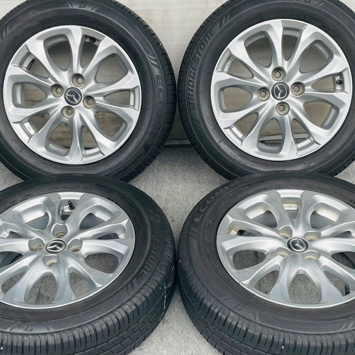 バリ溝。MAZDA マツダ DJデミオ純正15インチ×5.5J +40 100/4穴 BRIDGESTONE 185/65R15ラジアルタイヤ付き4本セット。MAZDA2　カペラなど。