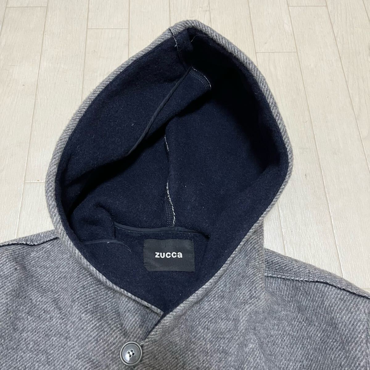 和621☆ zucca ズッカ ロングコート フード 比翼ボタン メンズ合わせ M 