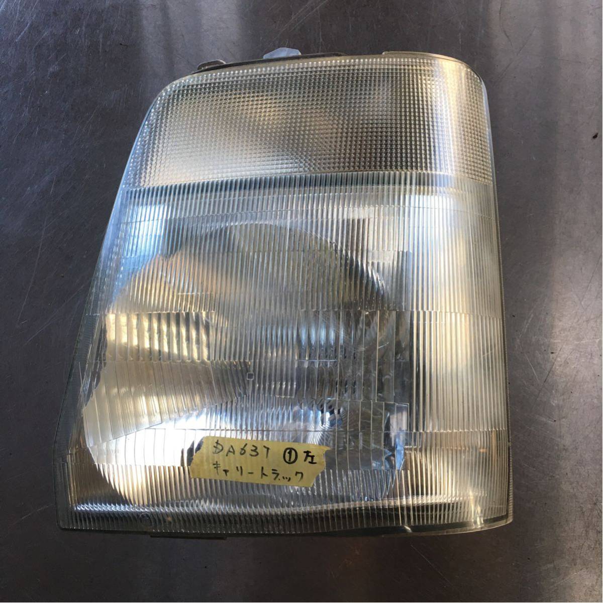 キャリー DA63T 左ヘッドライト ①